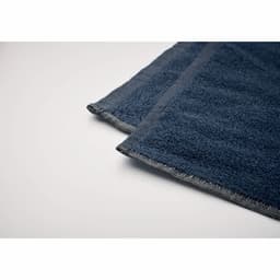 A dark grey towel with a textured surface, featuring stitched edges and a smooth finish.