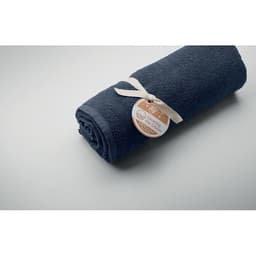 A rolled dark navy towel tied with a ribbon and featuring a tag. The surface is smooth and light.