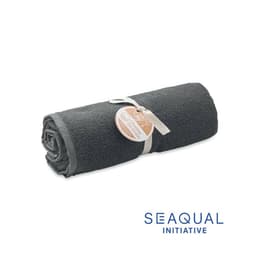 A rolled grey towel tied with a ribbon, featuring a tag. It includes a logo at the bottom right.