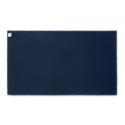 A navy blue mat with a textured surface and a small label in one corner.
