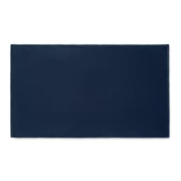 A rectangular navy blue mat with a textured surface, featuring a subtle logo in one corner.