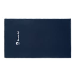 A navy blue promotional towel featuring a logo. The towel is rectangular and has a soft texture.