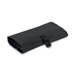 A black travel blanket rolled up and secured with a strap, featuring a smooth, lightweight fabric.