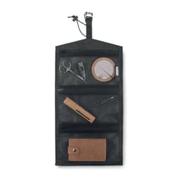 A hanging organiser in black mesh featuring multiple pockets containing scissors, a round mirror, and other accessories.