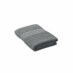 A grey towel folded neatly, featuring a textured band across the centre. It has a soft, plush appearance.