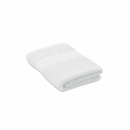 A white towel folded neatly with a textured pattern and a smooth band across the middle.