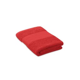 A red towel neatly folded, featuring a textured band across the centre. The product has a soft appearance.
