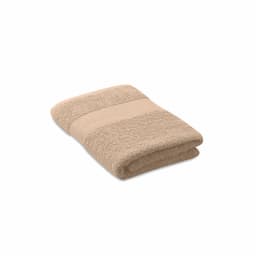 A folded beige towel featuring a textured band. The towel displays a soft, plush appearance.
