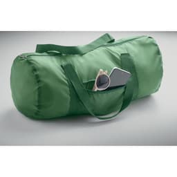 A green duffel bag featuring a pocket with sunglasses and a phone partially inserted.