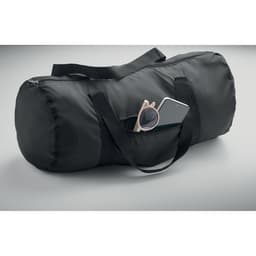 A black duffel bag with dual handles and a side pocket holding a pair of pink sunglasses and a smartphone.