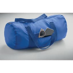 A blue duffle bag featuring a side pocket holding sunglasses and a smartphone. The bag has matching handles.