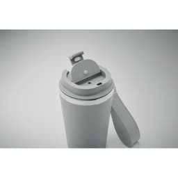 A drink bottle in grey with a flip-top lid and a handle for easy carrying. It features a sleek design and a logo.