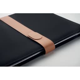 A black notebook with a tan leather strap closing it, featuring a smooth surface and simple design.