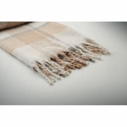 A throw blanket in soft beige and white plaid pattern, featuring fringed edges for added texture.