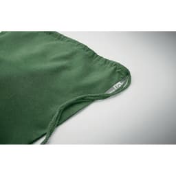 A green fabric item with gathered edges and a label, showcasing a smooth texture.