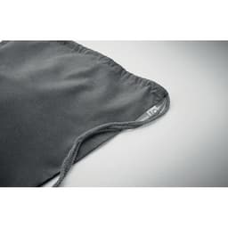 A grey drawstring bag with a textured finish and a small woven label on the side.