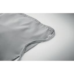 A grey fabric pouch with a drawstring, featuring a small tag. The material appears soft and smooth.