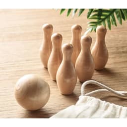 A wooden bowling set featuring seven pins and a ball, arranged on a wooden surface with a cloth bag nearby.
