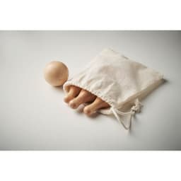 A drawstring bag containing three wooden legs and a wooden ball sits on a light background.