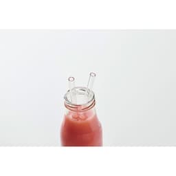 A drink bottle with a transparent lid, containing a pink beverage and two clear straws inserted.