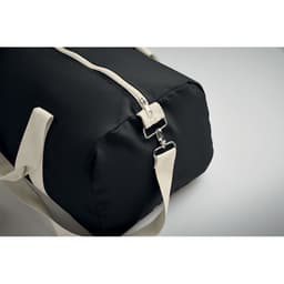 A black duffel bag with a cream handle and zipper detail, featuring a metal clasp.