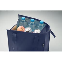 A navy blue cooler bag filled with water bottles, an apple, and two cans. The bag has mesh pockets and handles.