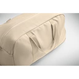 A beige duffel bag with handles, featuring a smooth exterior and a zippered opening.