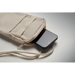 A cream pouch with a phone partially visible inside, featuring a zip and adjustable strap.