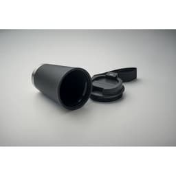 A drink bottle in matte black with a metallic silver base and a removable lid. It features a logo on its surface.