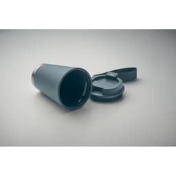 A drink bottle in navy blue with a silver base and a detachable lid. It features a handle for easy carrying.
