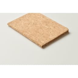 A cork notebook with a natural, textured surface, featuring a minimalist design and a neutral colour palette.
