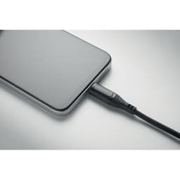 A smartphone connected to a charging cable. The cable features a textured black design.