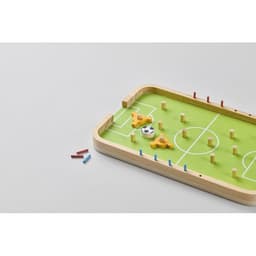 A tabletop football game featuring a green field, wooden frame, yellow players, a soccer ball, and red and blue goal posts.