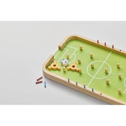 A tabletop soccer game with a green felt surface, wooden frame, and colourful player pieces in red and blue.