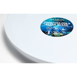 A white plate featuring a circular logo related to ocean conservation. The plate has a smooth, glossy finish.