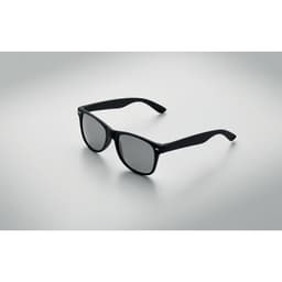 A pair of black sunglasses rests on a light grey surface, featuring dark lenses and a sleek design.