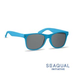 A pair of blue sunglasses with grey lenses, featuring a logo on the side.