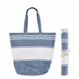 A tote bag in blue and white stripes, accompanied by a rolled-up matching blanket secured with a ribbon.