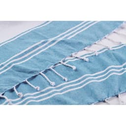 A textured blue and white striped fabric with tassels along the edges, featuring a soft, lightweight design.