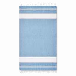A cotton beach towel in light blue, featuring white stripes and fringed edges. It has a simple, elegant design.