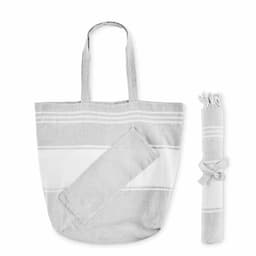 A grey and white striped tote bag with two handles, accompanied by a rolled blanket secured with a ribbon.