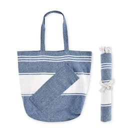 A denim-blue tote bag with white stripes, paired with a rolled-up matching towel, tied with a ribbon.