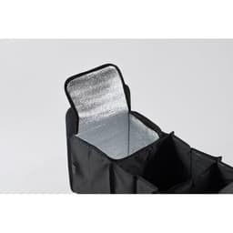 A black organiser bag with a silver insulated interior, featuring compartments and an open lid.