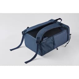 A navy blue promotional bag with adjustable straps and a mesh panel on one side. It has a logo on the front.