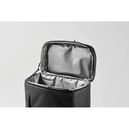 A black cooler bag with an open top, featuring a silver interior for insulation. It includes a zip closure and a side pocket.