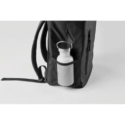 A drink bottle with a stainless steel finish is placed in a mesh pocket of a black backpack.
