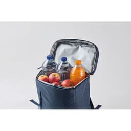 A lunch bag in navy blue containing three drink bottles and several apples. It has a silver insulated lining.