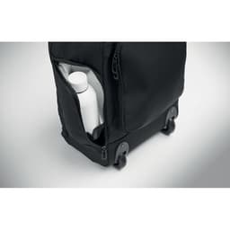 A black travel bag with a white drink bottle tucked into a side pocket. The bag features wheels and a sleek design.