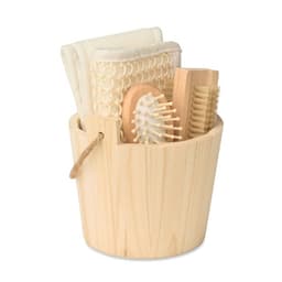 A wooden bucket containing natural-toned towels and various wooden hair care tools.