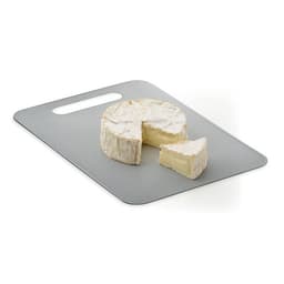 A cheese board with a round wheel of brie and a cut piece on a grey surface. The board has a handle.